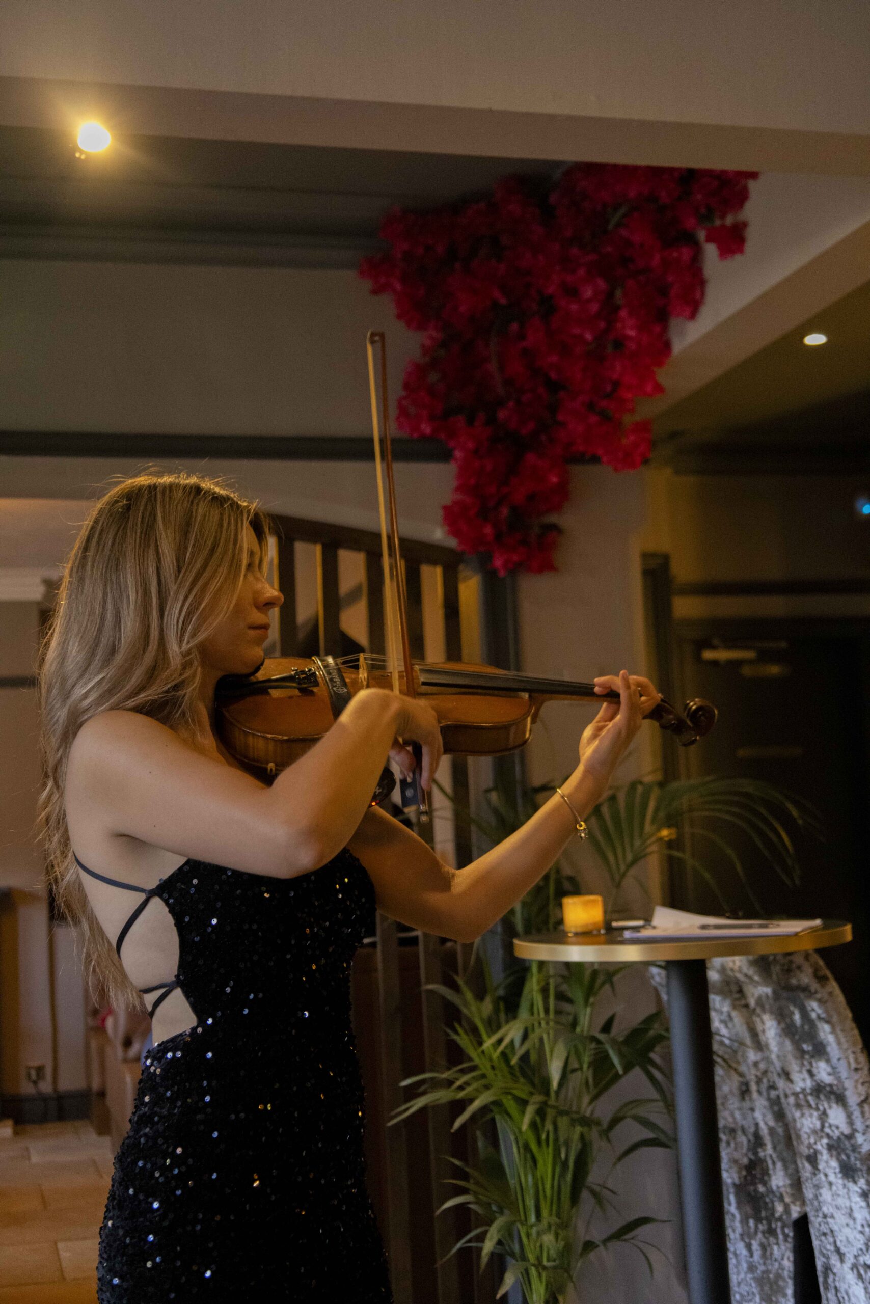 Violinist playing music for the glamorous opening night of Lasani