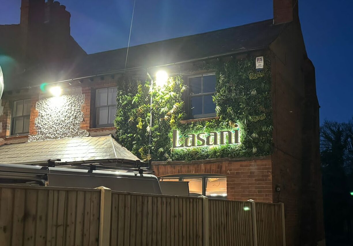 Lasani Restaurant, lit up at night.